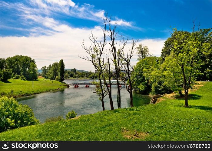 Korana river landscape in Karlovac, green landscape and bridge