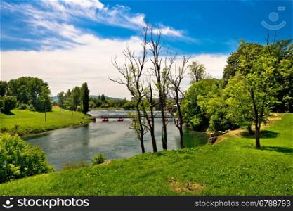 Korana river landscape in Karlovac, green landscape and bridge