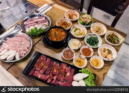 Korean BBQ set. Beef for grill on stove serve with vegetable and soup wood table , Japanese food style barbecue