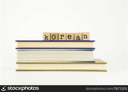 korean word on wood stamps stack on books, language and education concept