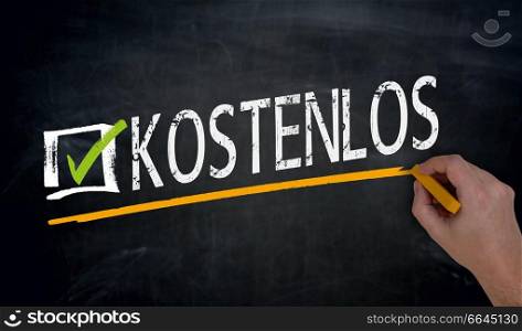 Kostenlos (in german Free) is written by hand on blackboard.. Kostenlos (in german Free) is written by hand on blackboard