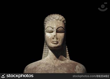 Kouros of the sacred gate ancient statue of young man on black background. Kerameikos museum, Athens Greece.