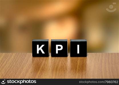 KPI or key performance indicator on black block with blurred background