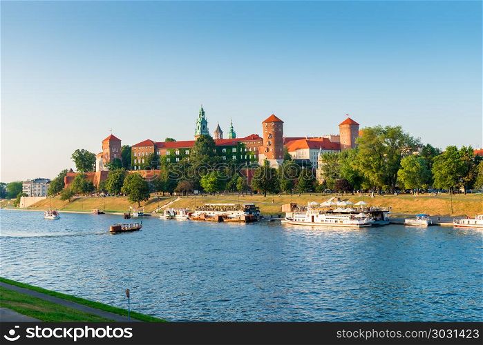 Krakow, Poland - August 11, 2017: Vistula River with tourist shi. Wawel Castle is located on a hill at an altitude of 228 meters on the bank of the Vistula River in Krakow. From the 11th to the beginning of the 17th century, the Wawel Castle was the residence of Polish kings and was the center of the country&rsquo;s spiritual and political power.