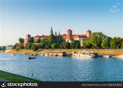 Krakow, Poland - August 11, 2017: Vistula River with tourist shi. Wawel Castle is located on a hill at an altitude of 228 meters on the bank of the Vistula River in Krakow. From the 11th to the beginning of the 17th century, the Wawel Castle was the residence of Polish kings and was the center of the country&rsquo;s spiritual and political power.