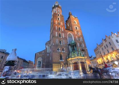 KRAKOW, POLAND - JUL 3: View of Kosciol Mariacki in market square on Jul 3, 2017 in Krakow, Poland. Church of Our Lady Assumed into Heaven is one of the best examples of Polish Gothic architecture.