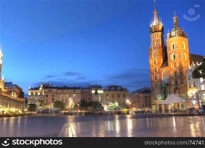 KRAKOW, POLAND - JUL 3: View of Main Market Square (Kosciol Mariacki) in sunset on Jul 3, 2017 in Krakow, Poland. Is one of the largest medieval town squares in Europe.