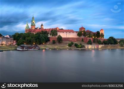 KRAKOW, POLAND - JUNE 29, 2017: The Wawel Castle and Wisla River in the Evening, Krakow, Poland. Wawel Castle was built at the behest of King Casimir III the Great.