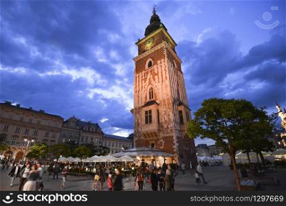 Krakow, Poland - May 25, 2019: Dramatic evening view on town hall tower on main square in Krakow, Poland .. Dramatic evening view on town hall tower on main square in Krakow, Poland .