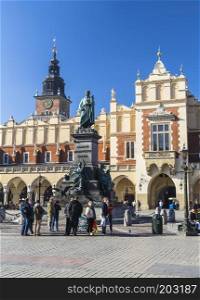KRAKOW, POLAND - OKTOBER 28, 2015  A monument to Adam Mickiewicz in the Market Square, the Cloth Hall and Town Hall. Krakow. Poland