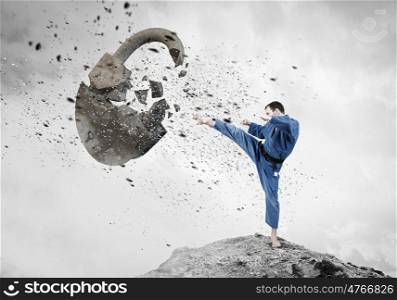 Krate man in action. Karate man in jump breaking stone lock