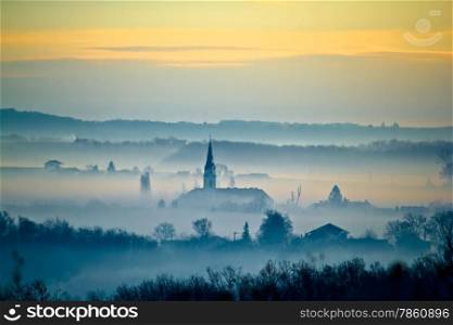 Krizevci cathedral in fog layers landscape, Prigorje region of Croatia