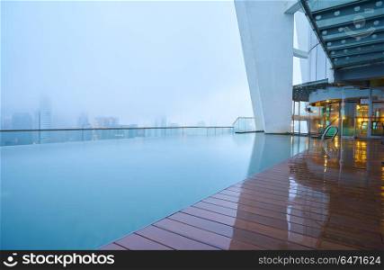 Kuala Lumpur, Malaysia - 02 April 2017 : Early morning swimming pool and skyline city view from the roof of Regalia Residence.