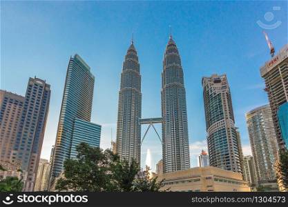 KUALA LUMPUR, MALAYSIA - AUGUST 14, 2016: Day time view of the front of Petronas Twin Towers in Kuala Lumpur, Malaysia with a clear deep blue sky