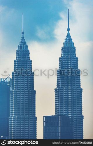 Kuala Lumpur, Malaysia ? February 21 2019 : Petronas Twin Towers (fondly known as KLCC) and the surrounding buildings during sunset seen from the Skybar