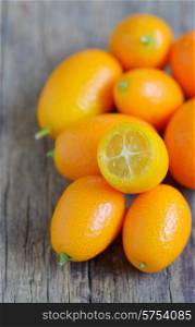 kumquat fruit on wooden table