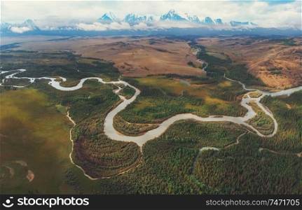 Kurai steppe and Chuya river on North-Chui ridge background. Altai mountains, Russia. Aerial drone panoramic picture.. Kurai steppe and Chuya river