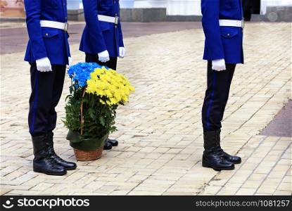 Kyiv, Ukraine - May 12, 2019: Mother?s Day, the military honors mothers and fallen soldiers as a result of the Russian military aggression in eastern Ukraine.. Kyiv, Ukraine - May 12, 2019: Mother?s Day, a basket with blue and yellow flowers, as a symbol of the flag of Ukraine.