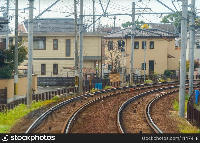 Kyoto, Japan - 01/03/2020 : Japanese railway with a local train run through city. Tourist attraction in travel and transportation concept. Steel structure industry architecture.