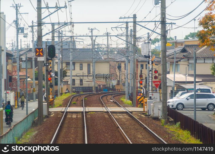 Kyoto, Japan - 01/03/2020 : Japanese railway with a local train run through city. Tourist attraction in travel and transportation concept. Steel structure industry architecture.