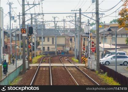 Kyoto, Japan - 01/03/2020 : Japanese railway with a local train run through city. Tourist attraction in travel and transportation concept. Steel structure industry architecture.
