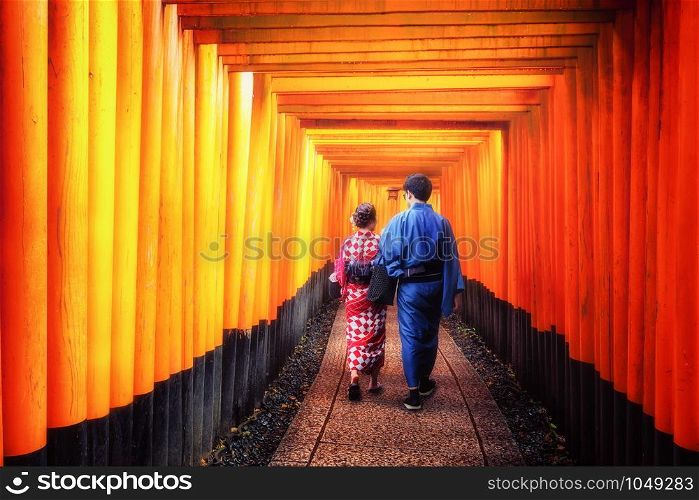 Kyoto, Japan Culture Travel - Asian traveler wearing traditional Japanese kimono walking in Fushimi Inari Shrine in the old town of Kyoto, Japan.