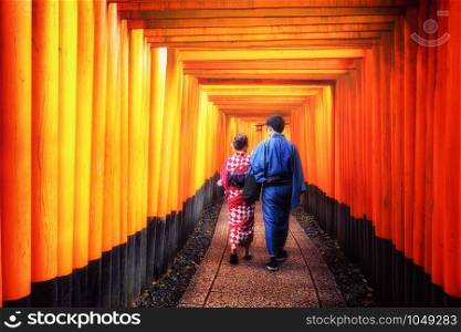 Kyoto, Japan Culture Travel - Asian traveler wearing traditional Japanese kimono walking in Fushimi Inari Shrine in the old town of Kyoto, Japan.