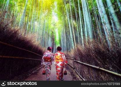 Kyoto, Japan Culture Travel - Asian traveler wearing traditional Japanese kimono walking in Arashiyama Bamboo Forest Grove in the old town of Kyoto, Japan.