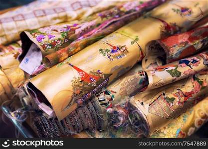 Kyoto, Japan - November 09, 2018: Close-up of kimono material for sale in a market in Kyoto city, Japan. Kimono textiles can to be classified into two categories: Gofuku, which indicates silk textiles in general, for luxuries and cotton/hemp Futomono for everyday wear.. Close-up of kimono material for sale in a market in Kyoto city, Japan
