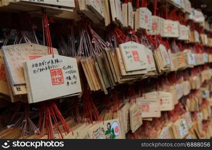 KYOTO, JAPAN -NOVEMBER 25, 2016: Ema votive pictures, which is a small wooden plaque for the prayers to write vows of love at Kiyomizu-dera Temple in Kyoto, Japan
