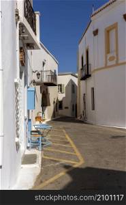 Kythira, Greece - August 26, 2021: Traditional alley and houses in the traditional settlement of Chora, the capital of Kythira island, Attica Greece.. Traditional alley and houses in the traditional settlement of Chora, the capital of Kythira island, Attica Greece.