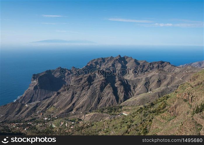 La Gomera landscape, Cliffs and canyons, La Palma island is in the background.