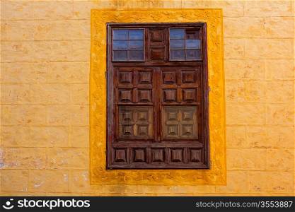 La Orotava wooden window in yellow wall Tenerife at Canary Islands