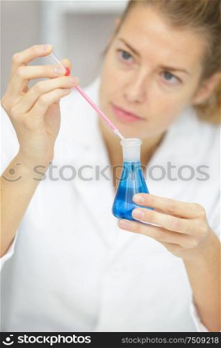 lab assistant in glasses holds in hands