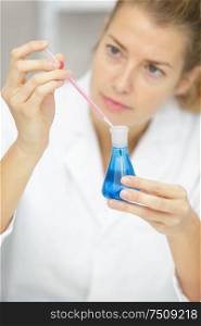 lab assistant in glasses holds in hands