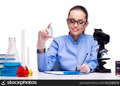 Lab chemist working with microscope and tubes