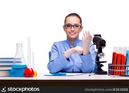 Lab chemist working with microscope and tubes