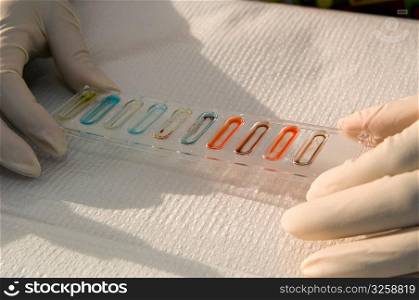 Lab technician doing blood type experiment.