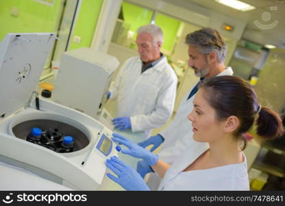 Lab technician using centrifuge machine