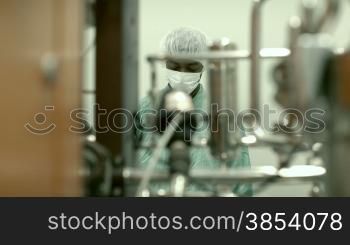 Lab technician working as researcher in biotechnology plant with machinery
