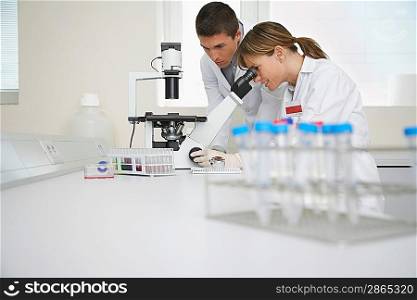 Lab Technicians Using Microscope