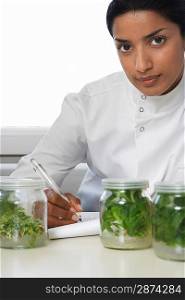 Lab Worker Examining Jars of Herbs