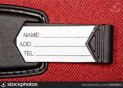 Label with identification data on red textural fabric