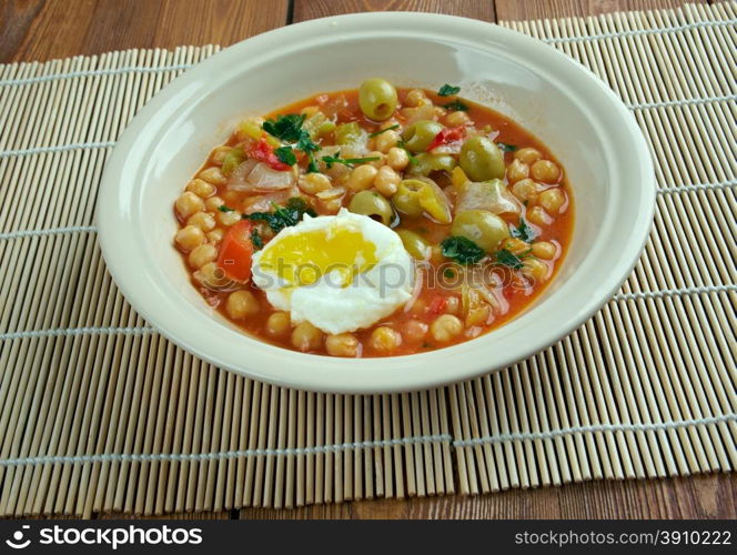 Lablabi - Tunisian dish based on chick peas. Raw or soft-cooked egg ,mix along with olive oil, harissa, and sometimes olives, garlic and vinegar