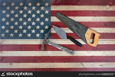 Labor Day background with USA rustic wooden flag and used industrial tools