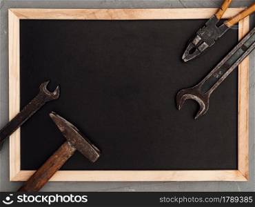 LABOR DAY. Hand tools lying on the table. View from above, close-up. Preparing for the celebration. Congratulations to loved ones, family, relatives, friends and colleagues. National holiday concept. Hand tools lying on the table. Top view
