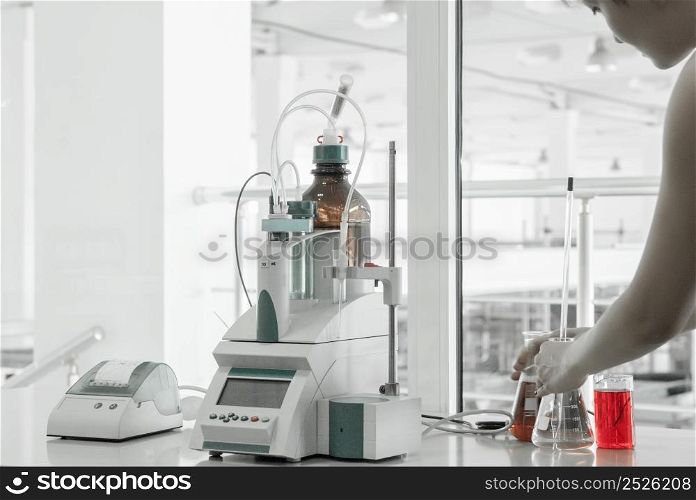 laboratory assistant conducts research and testing. test laboratory for manufacturing and processing of plastics. equipment in industrial laboratory