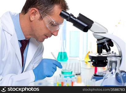 laboratory scientist working at lab with test tubes and microscope