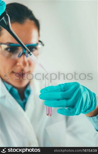 Laboratory technician using micro pipette
