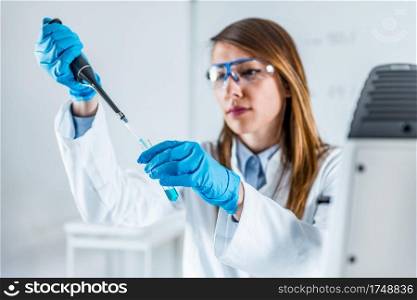 Laboratory technician using micro pipette